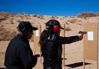 David Brown assisting a student on the firing range